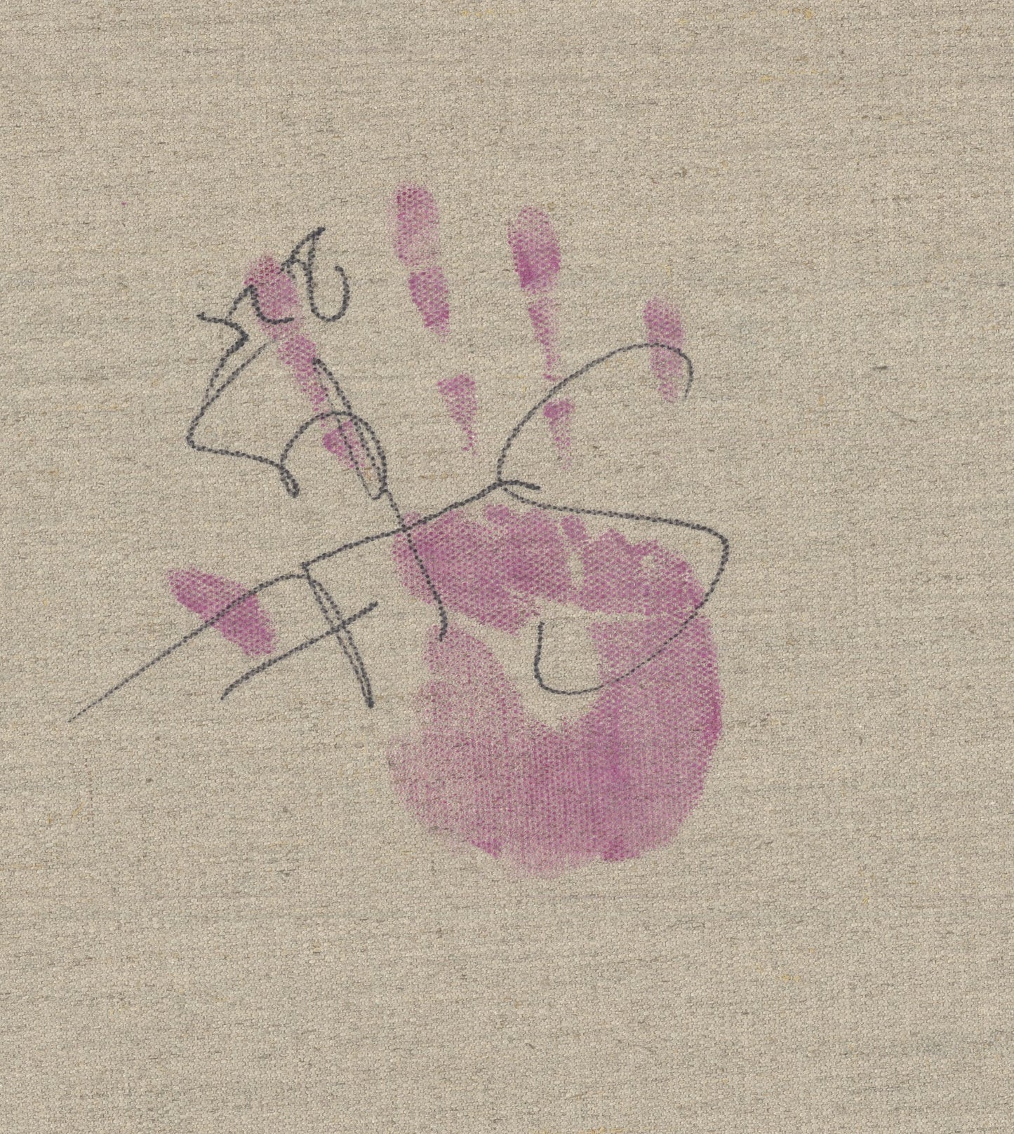 A small child's handprint in soft pink pigment on natural linen, overlaid with looping black pen marks resembling early drawing or a signature.