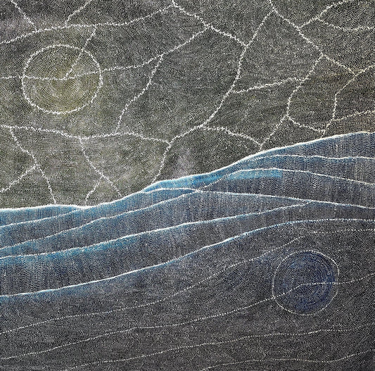 Aerial style dot painting with cracked ochre terrain above and sweeping blue dune lines below, two pale circular forms anchoring opposite corners.